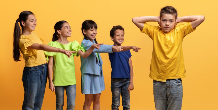 Angry cruel teenagers laughing at their classmate, yellow background